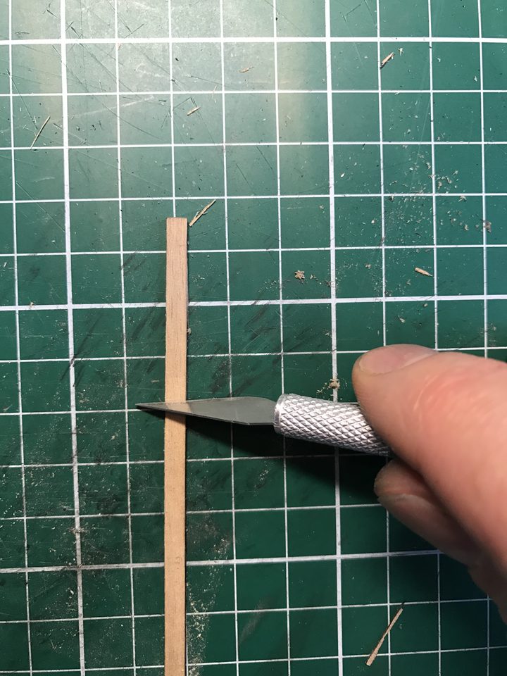 Scraping with a new blade: testing the grain and smoothing the plank.