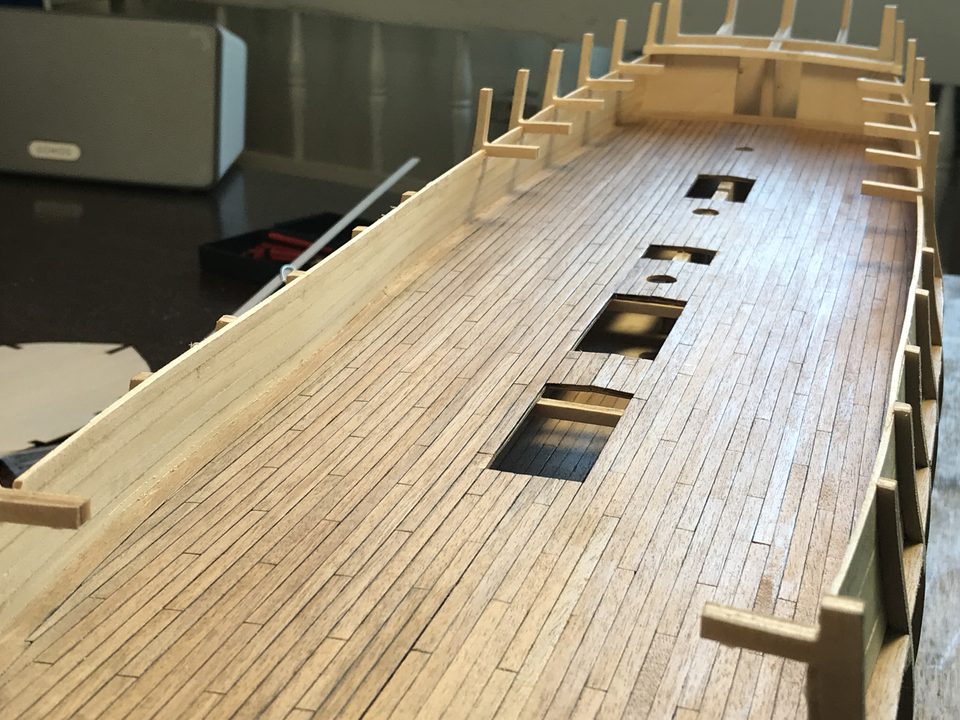 Along the length of the gun deck