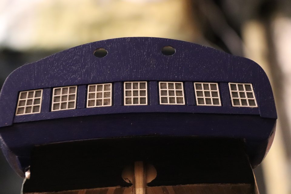 All the windows are in the transom: clear plastic with a grey haze, so they shine without showing the stern frames behind them.