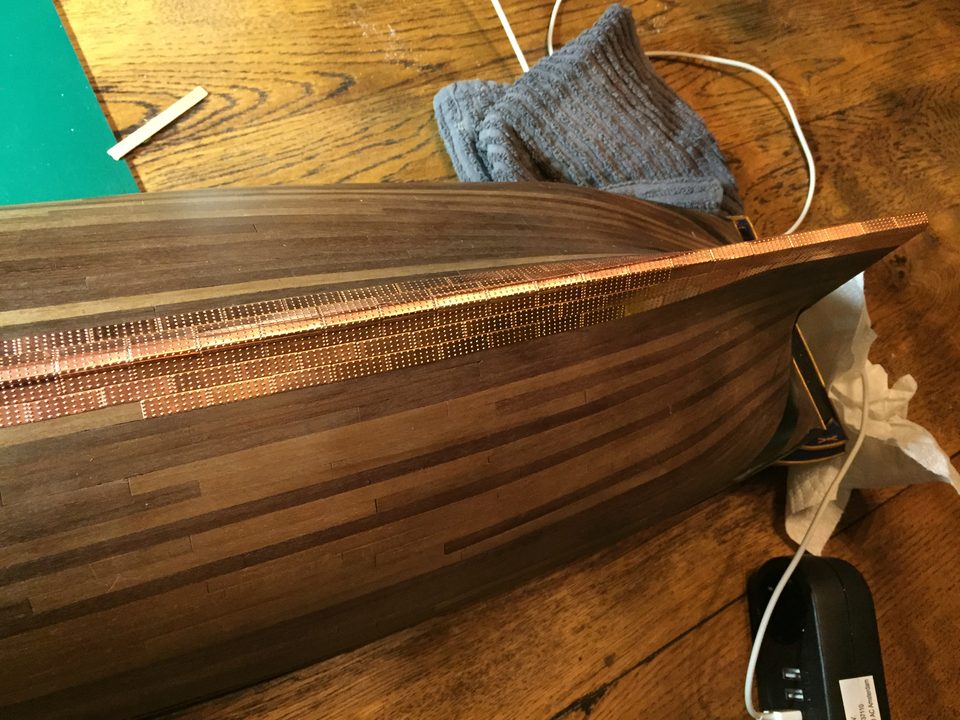 Plate by plate along the keel: press down only once the plate lies against its neighbour.