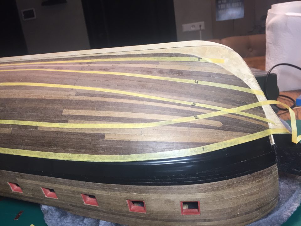 The result: the belts marked out on the hull with masking tape, all running with the sheer of the planking.