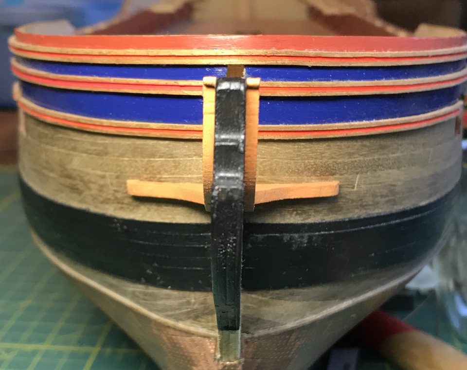 The cathead passes straight through the continuous mouldings; that opening was cut out later with a very sharp knife.