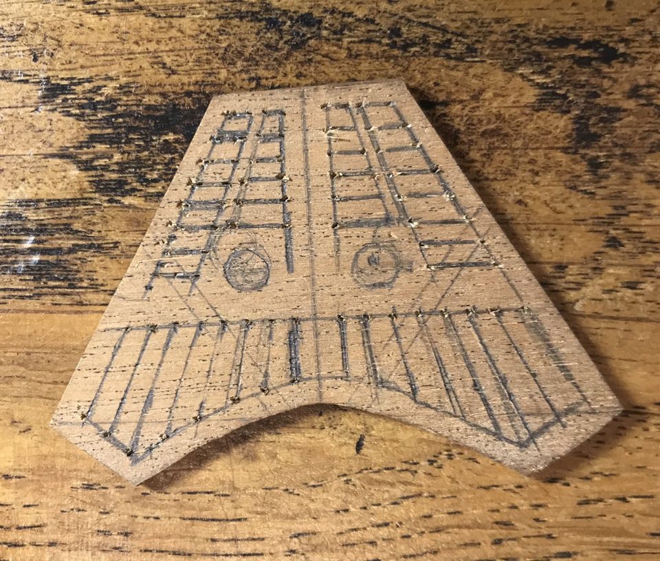 The grating with all openings marked in pencil, ready for cutting.