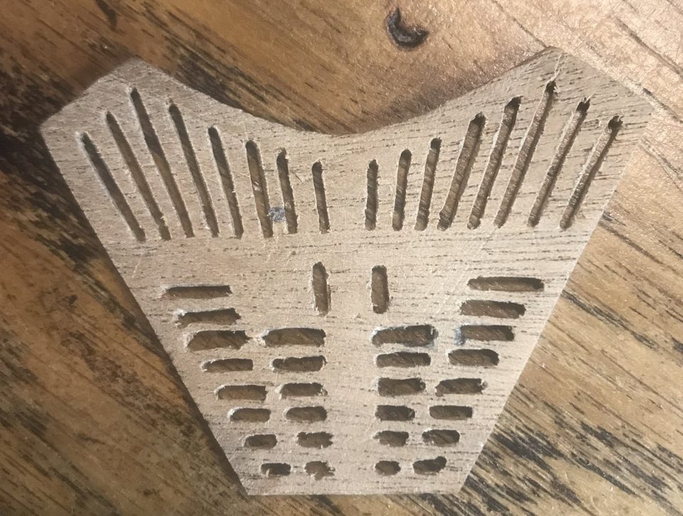 The first attempt with drilled holes: the openings vary in width and the edges are ragged.