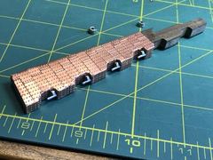 The pintles in their holes, with holes cut in the copper