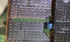 The first pintle strap glued on, with the pre-punched holes