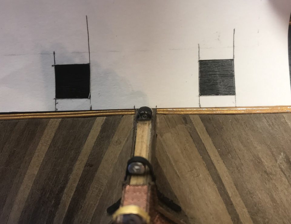 The paper template against the transom, with the two lids as black squares in the right place.