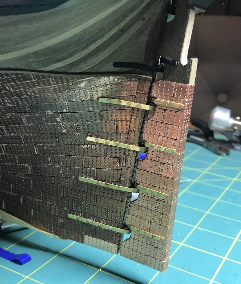 Before scrubbing: the sternpost with the light glue marks among the dark plates.