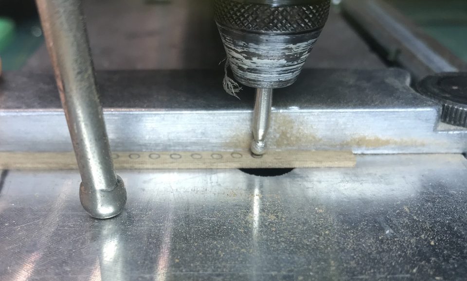 The strip under the pillar drill; each circle is filed into a hollow.