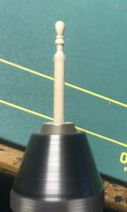 The turned handle on the quoin of a gun