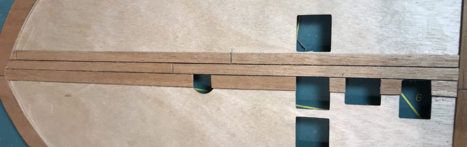 Detail of the caulking seams: the thread draws a thin dark line between the planks.