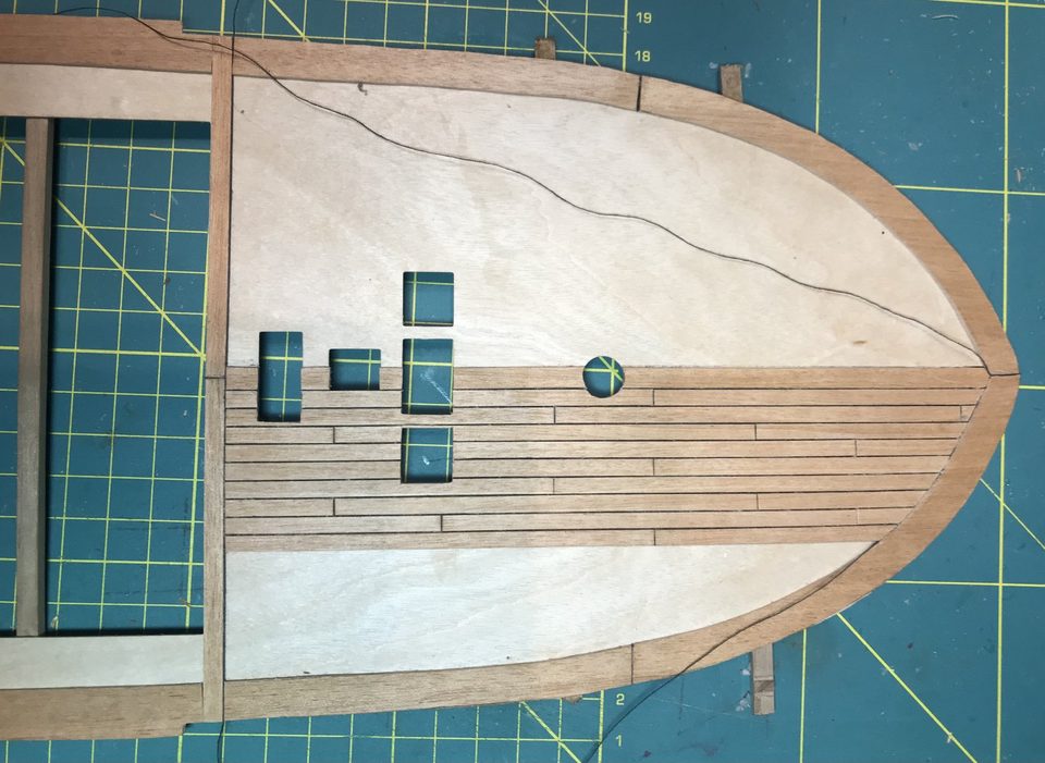 The result after a day of laying: king plank, margin plank and the first planks with dark thread seams, joggled symmetrically at the bow.