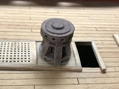 The capstan on the oak plate, with the open ladderway beside it