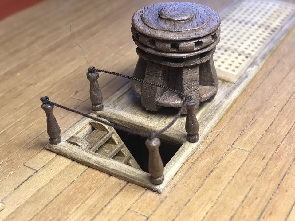 The result: four matching walnut stanchions round the ladderway by the capstan, with brass rings and the rope between them.
