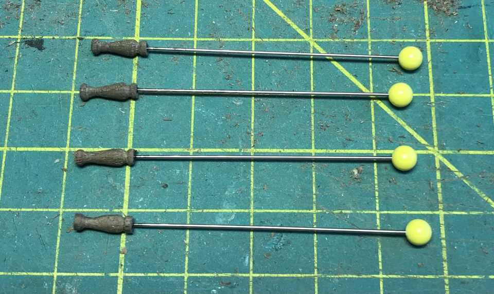 The four stanchions with the pins glued in, before they are cut short.
