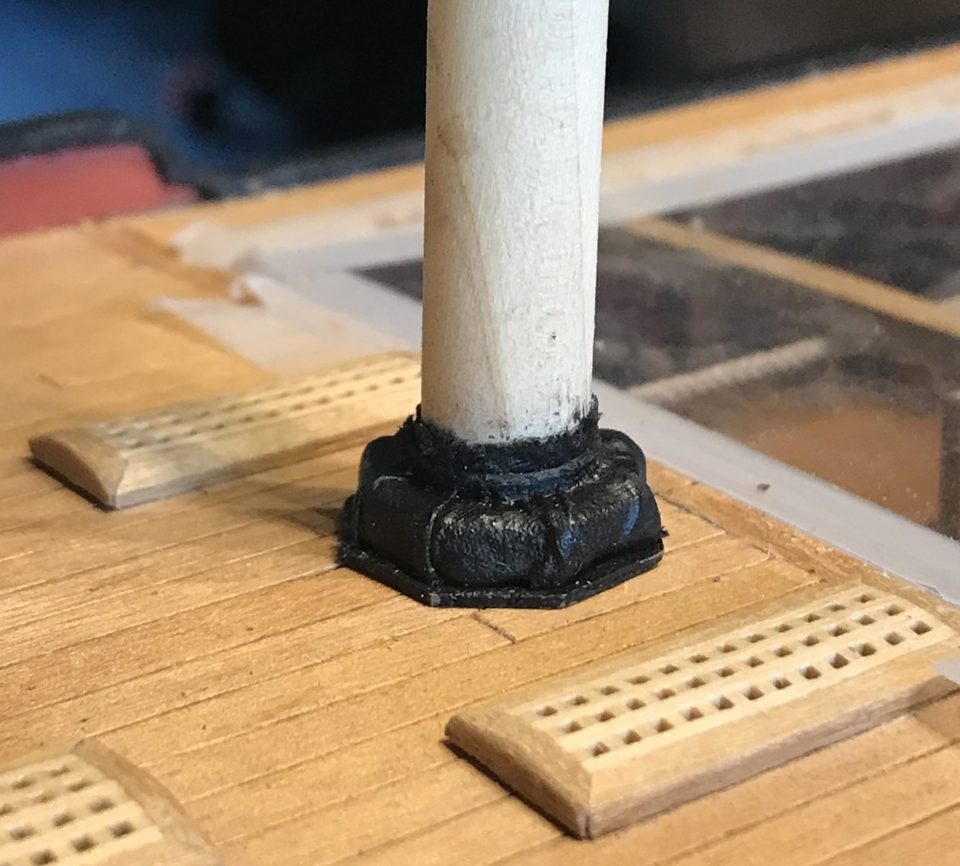 The tight version after a small adjustment: the notches of the wedges show through the cloth, with black smears from the tarring on the mast.