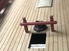 Bitts next to a ladderway, with a mast coat behind