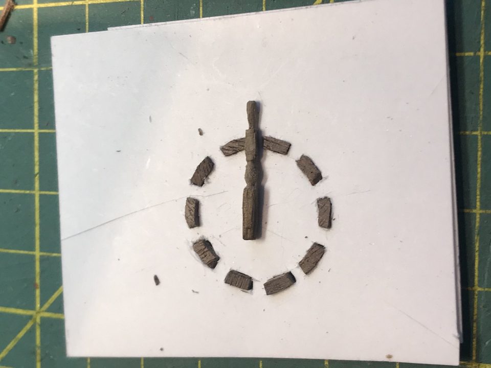 Set-up for the ship's wheel: the bits of wood in a circle on the jig, with a trial spoke