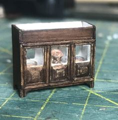 The lantern in the middle window, the compasses on either side