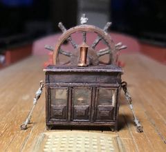 The binnacle on deck, in front of the ship's wheel
