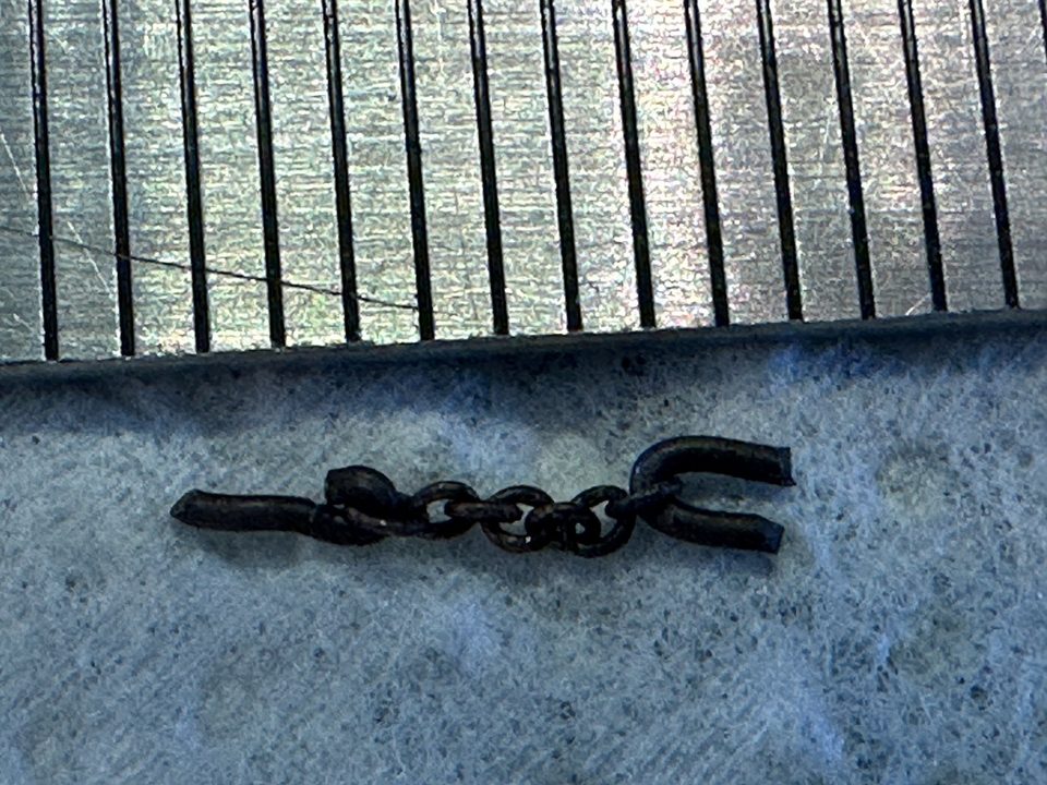 The little chain next to a ruler, each mark is 1 mm