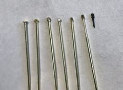 The various stages from brass dressmaker's pin to linchpin