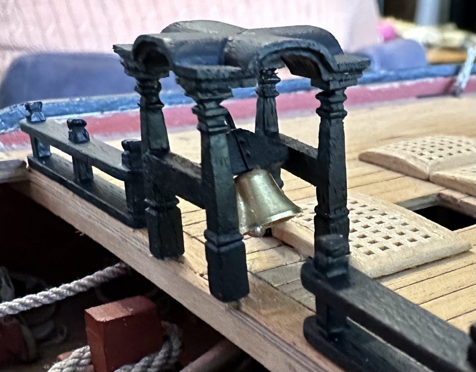 From the side: the feet stand just over the edge, next to the notched grating