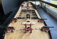 Overview from the bow: four guns, the bitts with the mast coat and the belfry