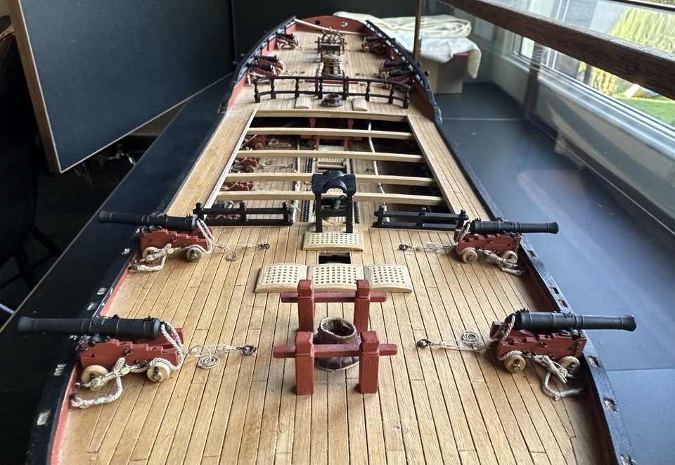 Overview from the bow: four guns, the bitts with the mast coat and the belfry