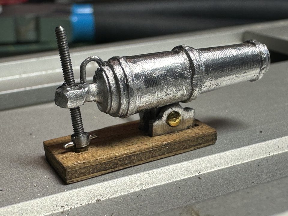 The elevating screw from a 1.2 mm bolt: the rounded head with the pin as handle, under the breech of the carronade.