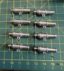 The eight carronades, each with its own elevating screw, still in bare white metal