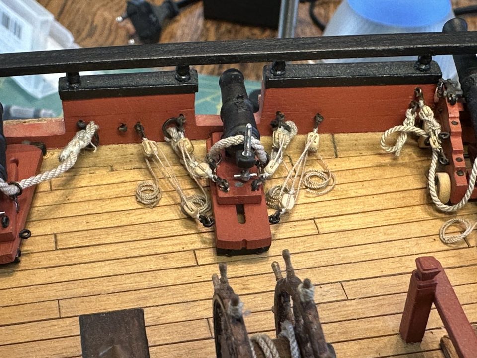 A rigged carronade close up, with breeching, gun tackles and the elevating screw