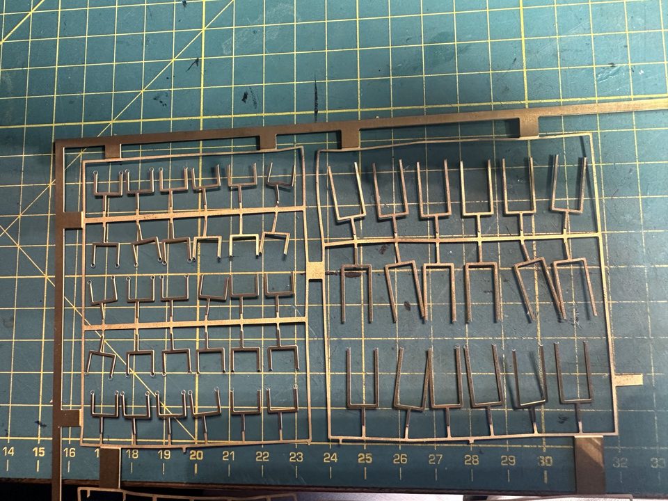 The hammock cranes from the kit on their etched sheet, mostly bent or broken off