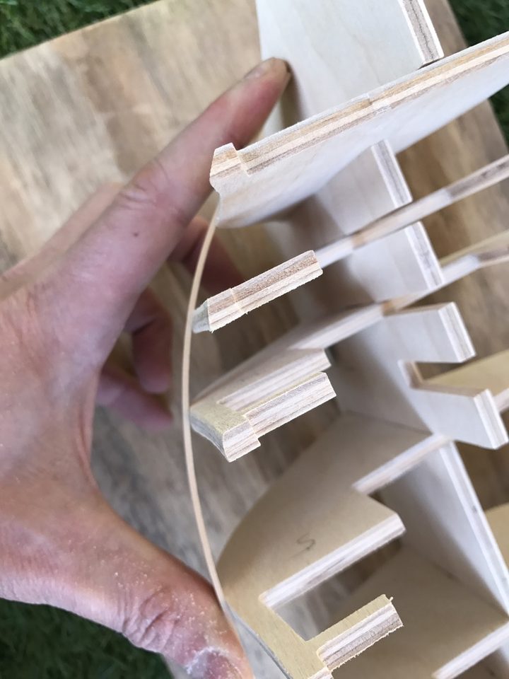 The strip pressed against the foremost bulkheads: where it does not touch, material still has to come off or be added.