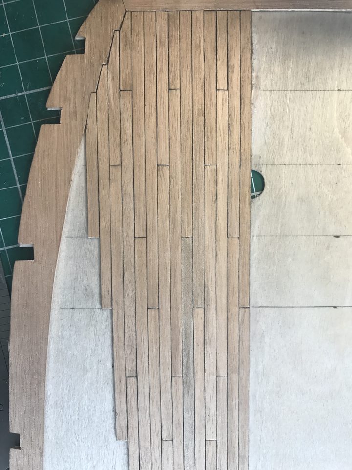 The deck after the first weekend: rows beside the king plank and the start of the joggling at the bow.