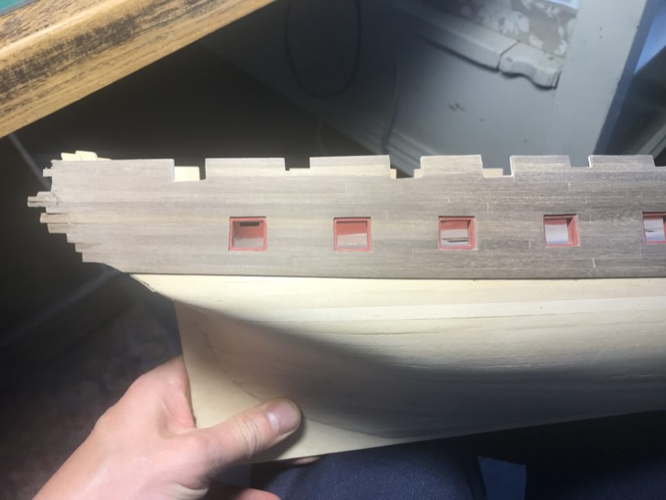 The hull on her side, with the planking above the wale facing upwards.