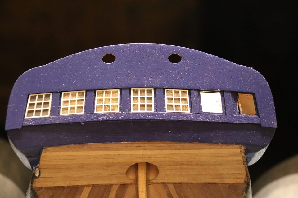 Halfway: the left-hand windows are already in the transom with their grey panes, on the right the openings are still empty.