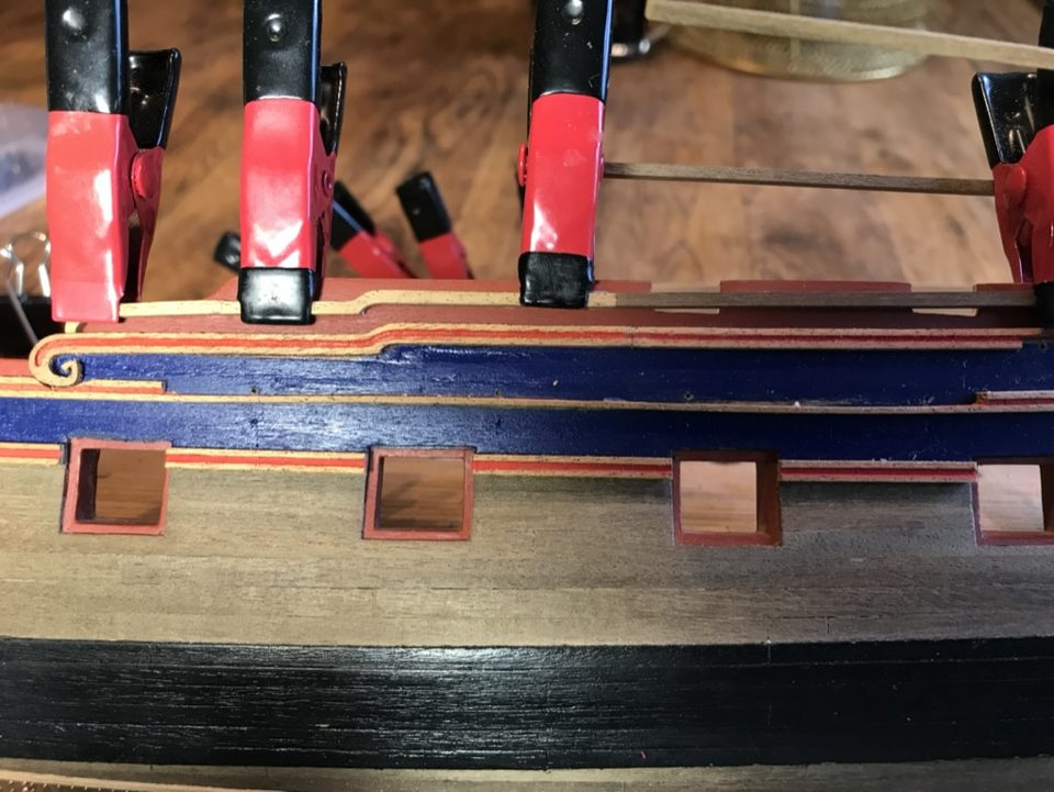 A moulding on the port side glued with a row of small clamps, the gunports below it clear.