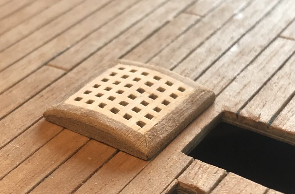 The first grating with the camber; the coaming runs out lower at the sides than in the middle.