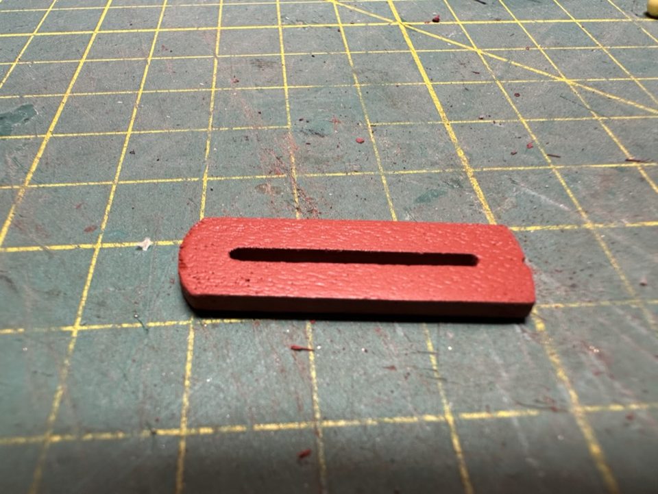 The bed with the slot that the rod of the slide runs through.
